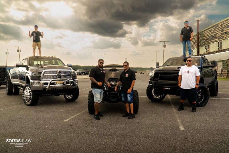 owners of custom vehicles posing for a photo