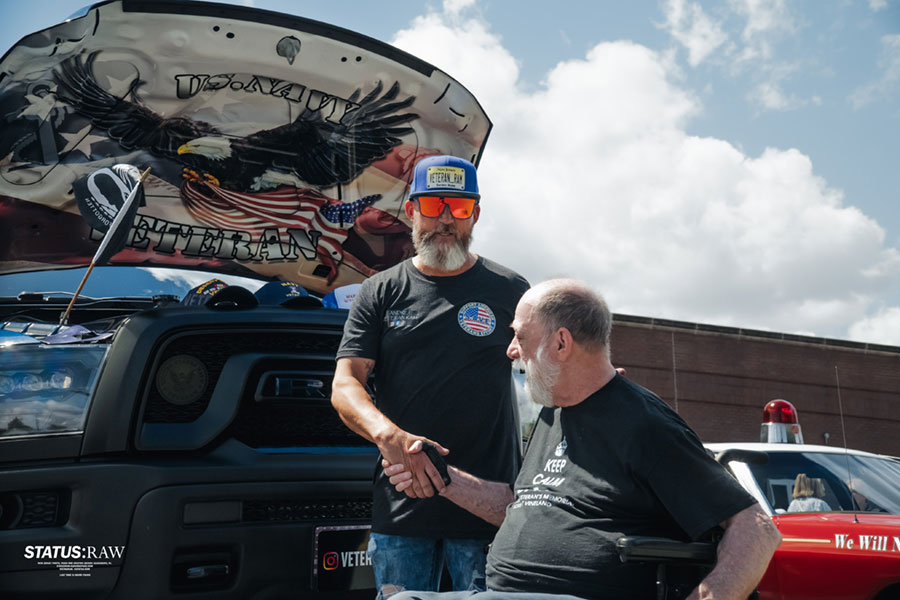 Andre shaking hands with a veteran at an event