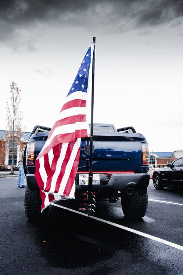 back of Veteran RAM truck with an American flag attached