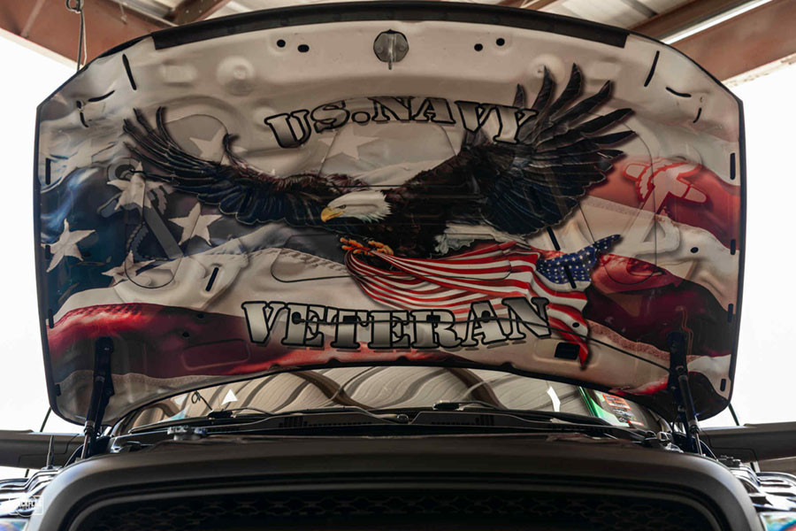 Custom hood artwork that says "U.S. Navy Veteran" and depcits a bald eagle flying with an American flag