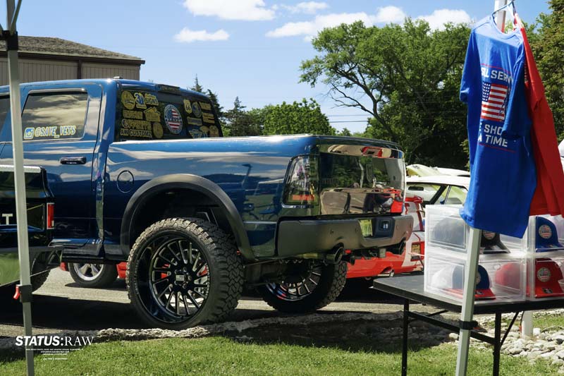 Truck parked near veterans booth with shirts and display items