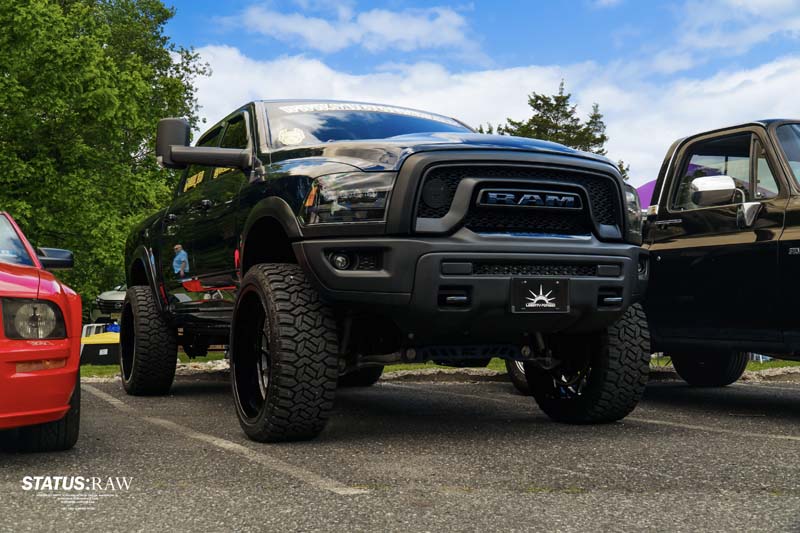 Lifted black Ram truck parked at outdoor car event