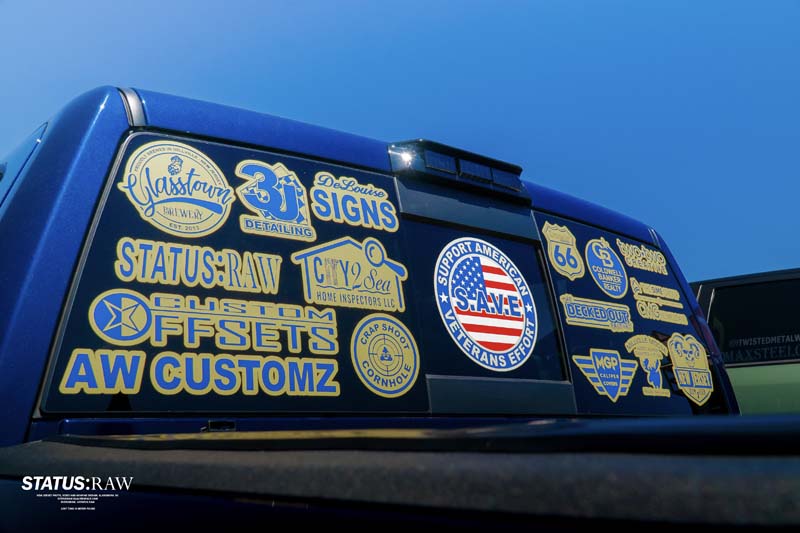 Pick-Up Truck with lots of sticker on the back wind-shield