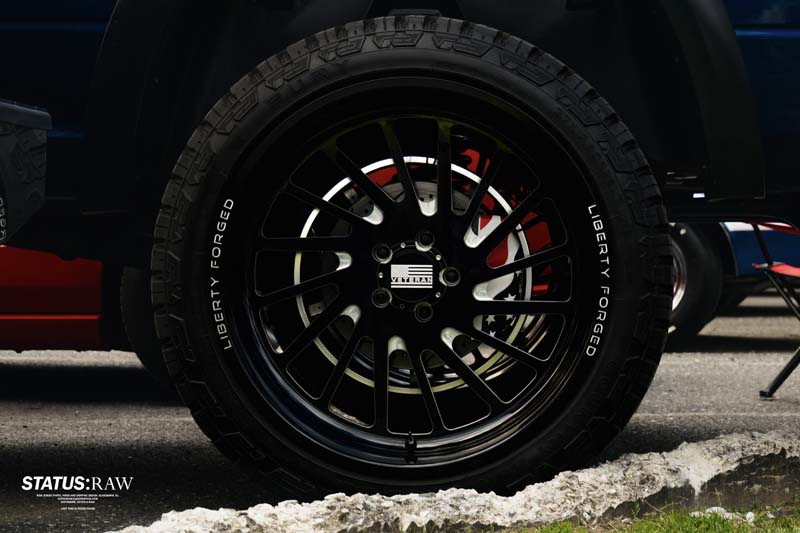 Close up of black truck wheel and tire with custom rim