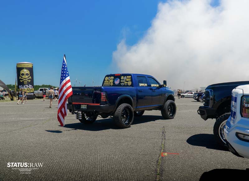 RAM pick-up truck with American flag attached.