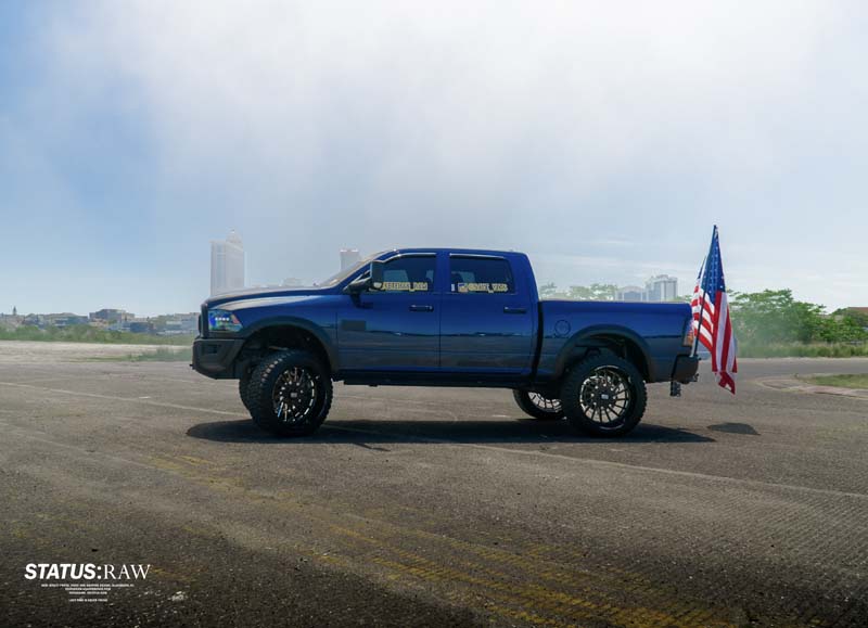 RAM pick-up truck with American flag attached.